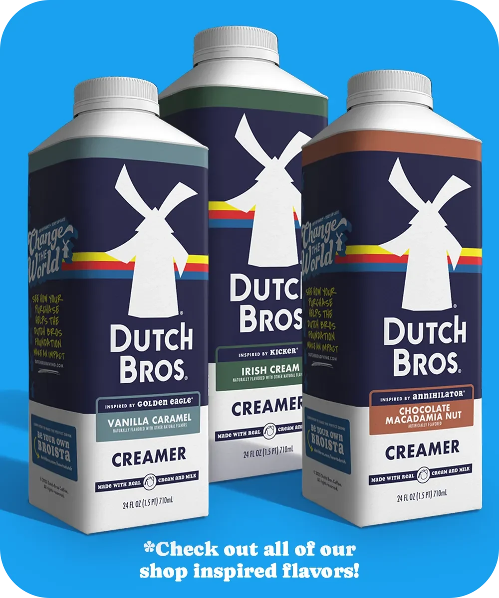 Three Dutch Bros coffee creamers in different flavors: Vanilla Caramel, Irish Cream, and Chocolate Macadamia Nut against a blue background.