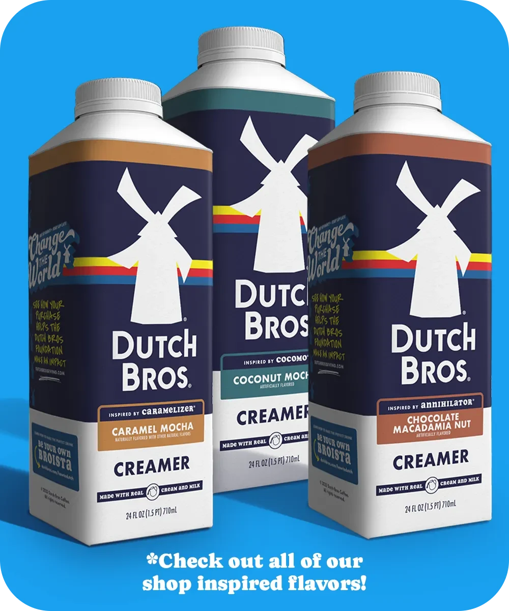 Three Dutch Bros coffee creamers in different flavors: Caramel Mocha, Coconut Mocha, and Chocolate Macadamia Nut on blue background.