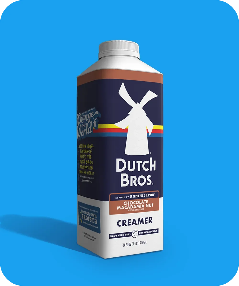 Dutch Bros Chocolate Macadamia Nut coffee creamer carton with windmill logo against bright blue background.