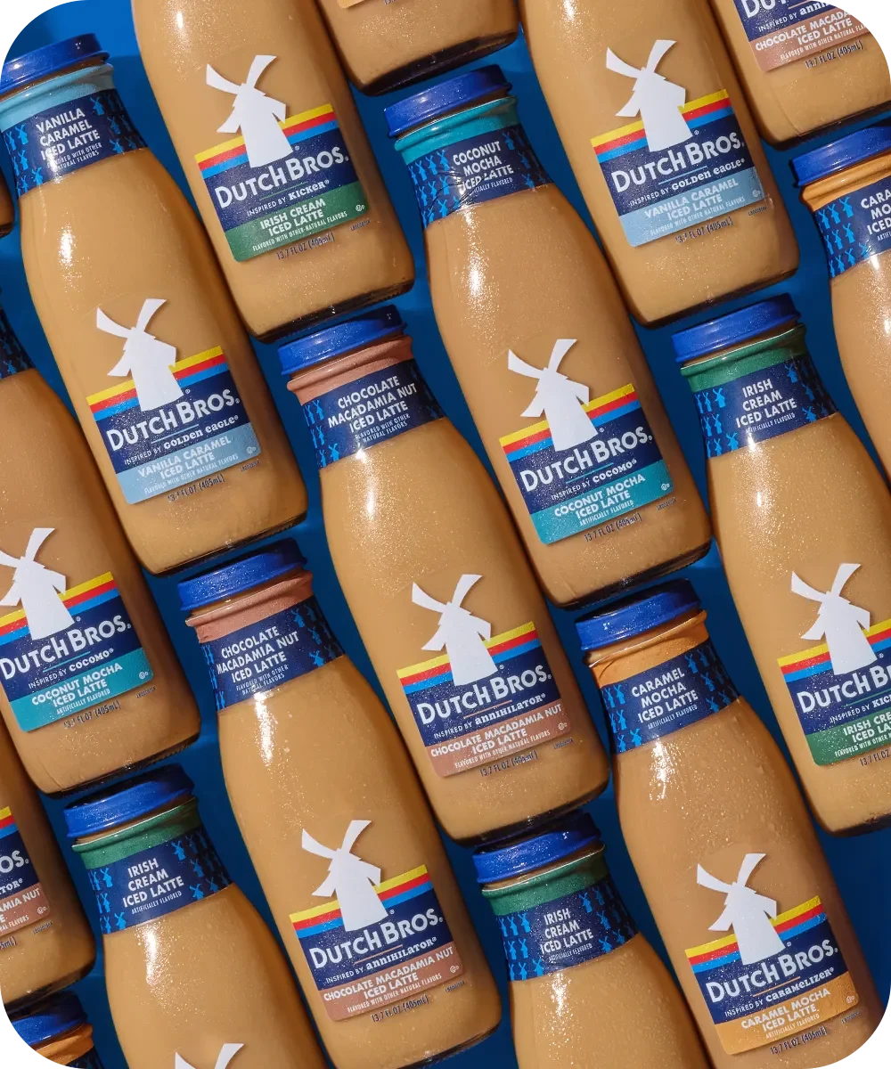 Rows of Dutch Bros bottled iced coffee drinks in various flavors including Irish Cream, Coconut Mocha, and Caramel.